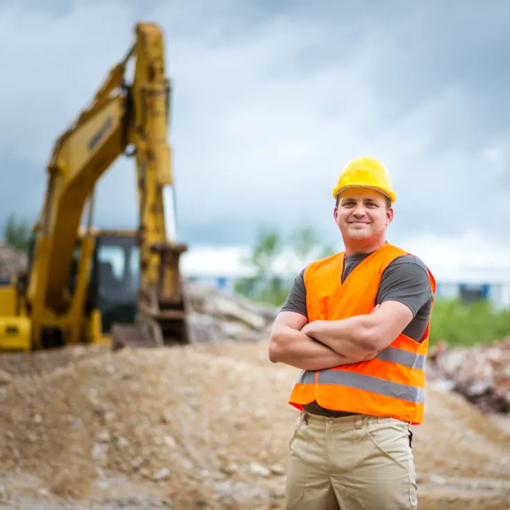 man standing near excavator